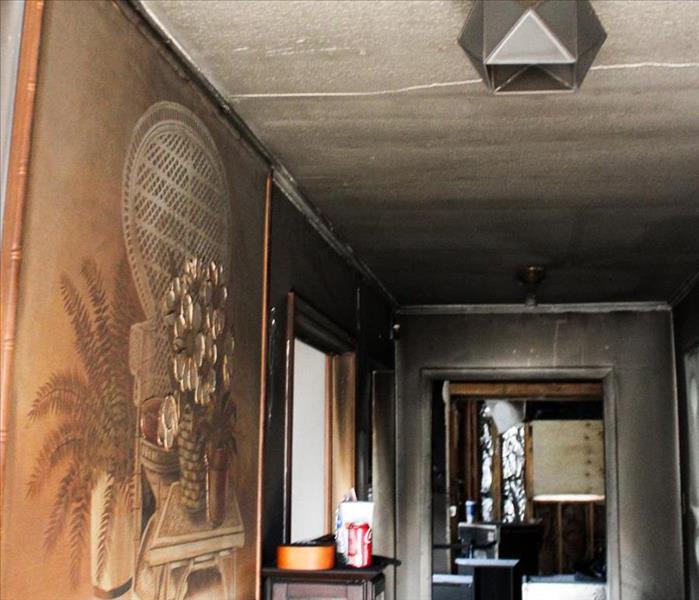 Entrance hall covered in soot due to fire.